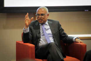 President Neves sitting in a red chair during his public talk at MIT