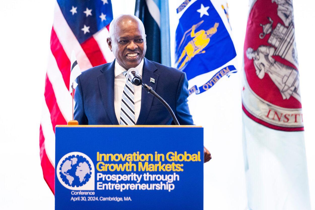 President Masisi behing a podium in front of flags