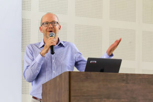 Man with glasses and blue shirt